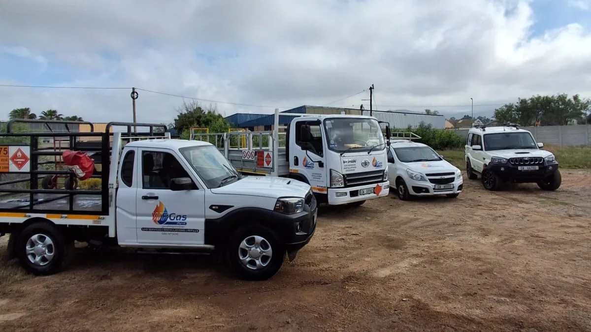 The WF Gas fleet: a branded bakkie with a cylinder cage, the gas truck, a car and a 4x4